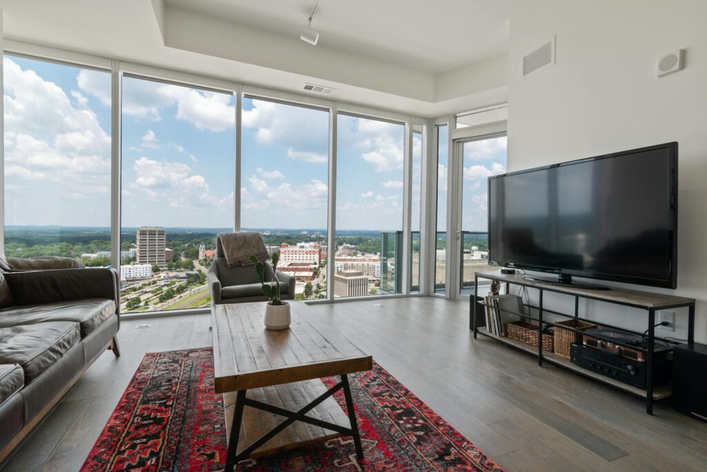 Bright modern penthouse with large glass windows and city panorama