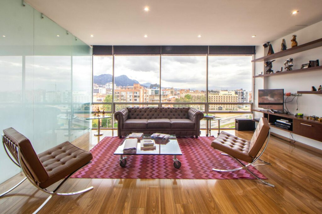 Stylish minimalist penthouse living room with cityscape views